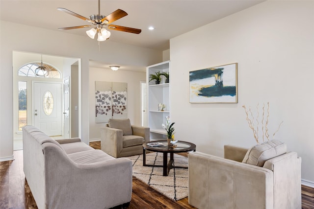 living room featuring ceiling fan and dark hardwood / wood-style flooring