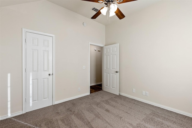 unfurnished bedroom featuring carpet flooring, ceiling fan, and vaulted ceiling