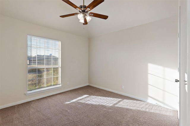 carpeted spare room featuring ceiling fan, a healthy amount of sunlight, and vaulted ceiling