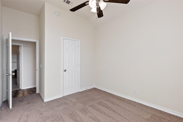 unfurnished bedroom with carpet flooring, ceiling fan, a closet, and vaulted ceiling