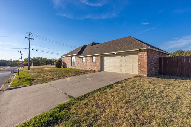 view of property exterior featuring a garage and a yard