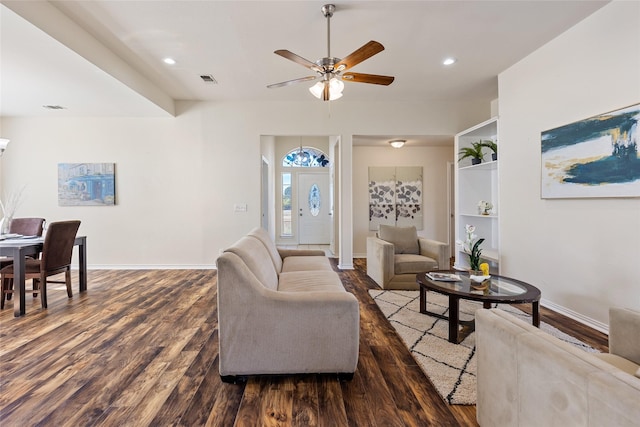 living room featuring ceiling fan and dark hardwood / wood-style floors