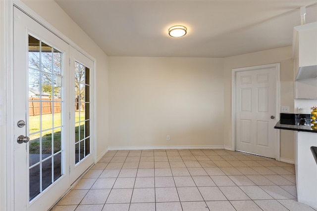 unfurnished dining area with light tile patterned floors