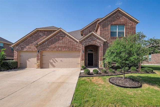 view of property with a garage and a front lawn