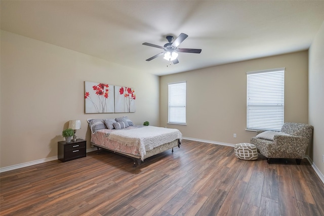 bedroom with dark hardwood / wood-style floors and ceiling fan