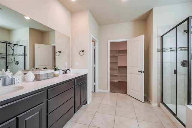 bathroom featuring an enclosed shower, vanity, and tile patterned flooring