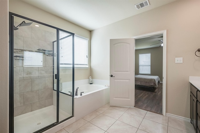 bathroom featuring plus walk in shower, tile patterned flooring, vanity, and ceiling fan