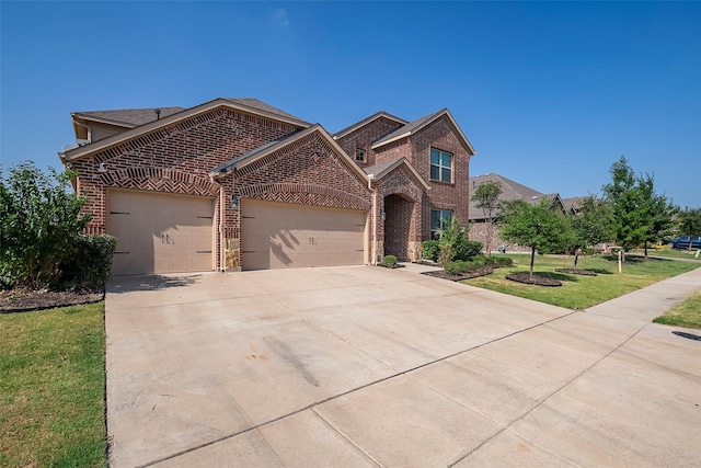 view of front of property featuring a garage and a front lawn