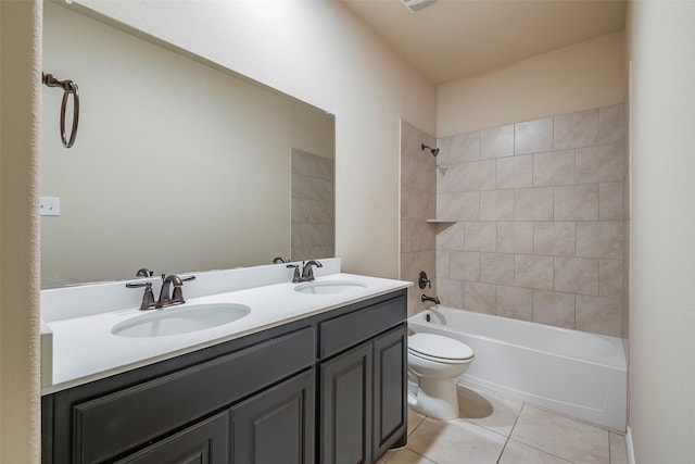 full bathroom featuring vanity, toilet, tiled shower / bath combo, and tile patterned flooring