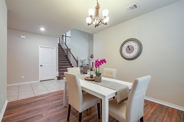 dining space featuring an inviting chandelier and light hardwood / wood-style flooring