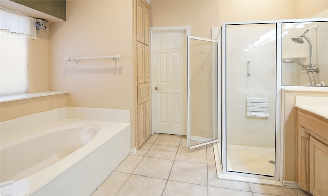 bathroom with tile patterned flooring, vanity, and independent shower and bath