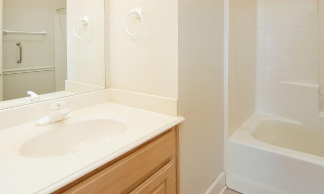 bathroom featuring bathing tub / shower combination and vanity