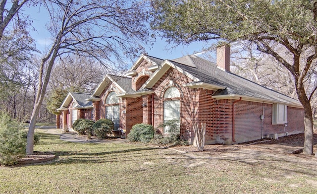 view of side of property with a yard