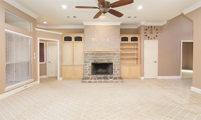 unfurnished living room with ornamental molding, a large fireplace, light tile patterned floors, and ceiling fan