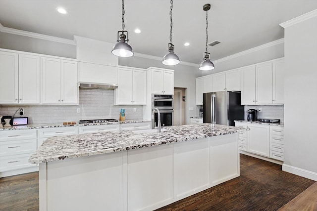 kitchen featuring white cabinetry, an island with sink, and appliances with stainless steel finishes