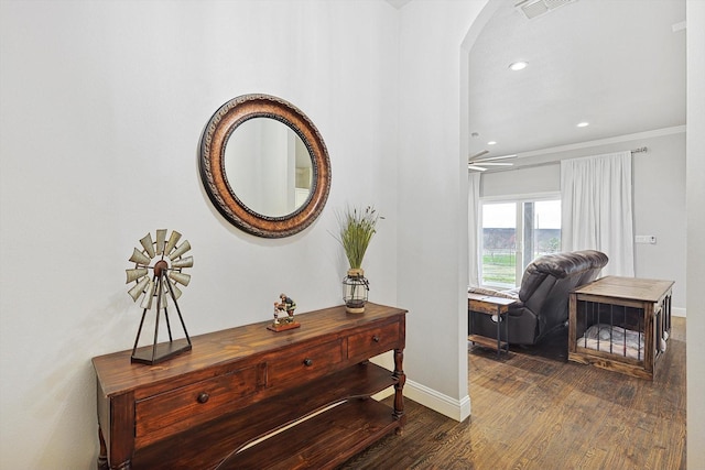 interior space featuring dark hardwood / wood-style floors and ornamental molding