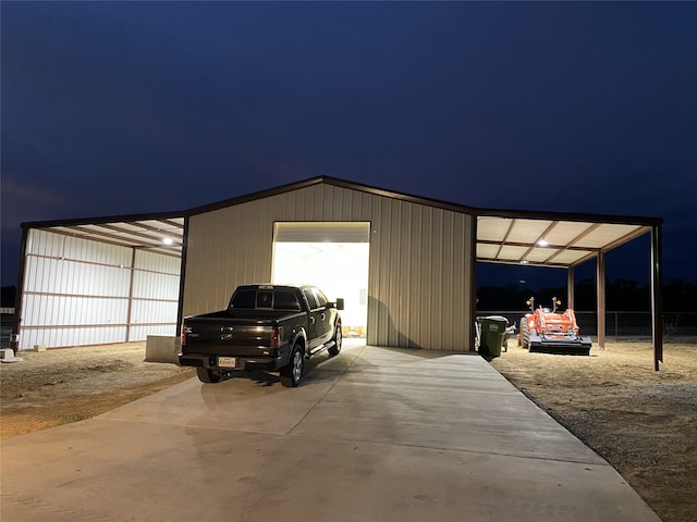 view of garage at twilight