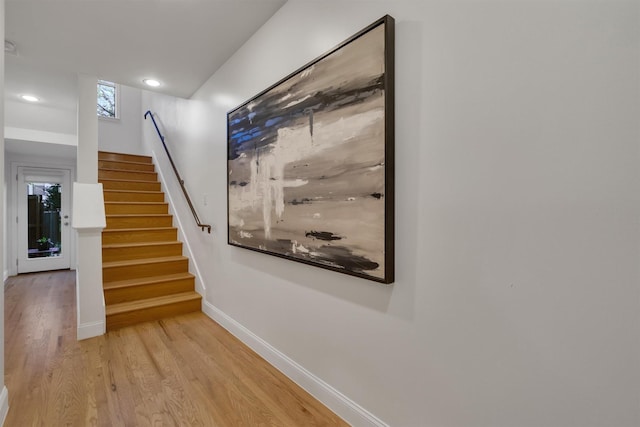 stairs featuring hardwood / wood-style flooring