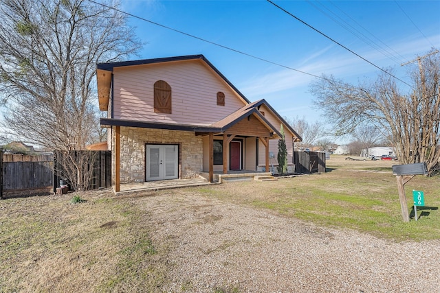 view of front of property featuring a front yard and french doors