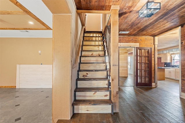 stairway with hardwood / wood-style flooring, sink, and wood ceiling