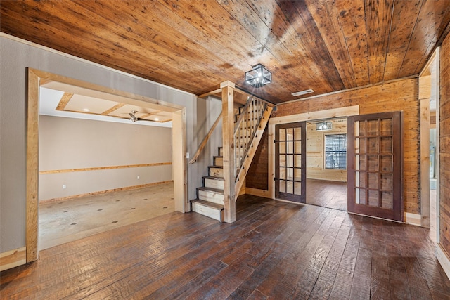 basement with dark hardwood / wood-style flooring, wood ceiling, french doors, and wood walls