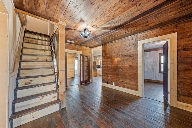 interior space featuring wood-type flooring, wooden ceiling, and wood walls