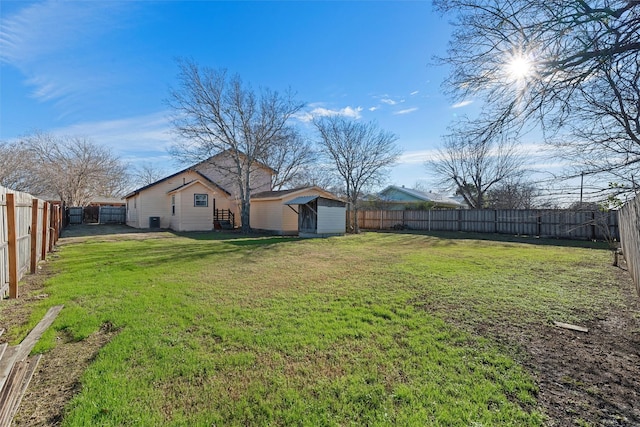 view of yard with a fenced backyard and an outdoor structure