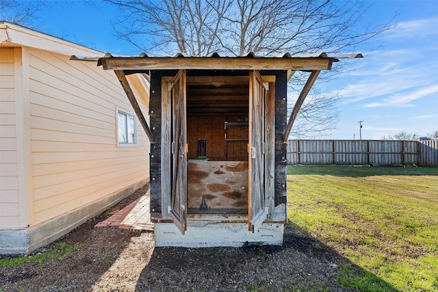 view of outdoor structure featuring a lawn