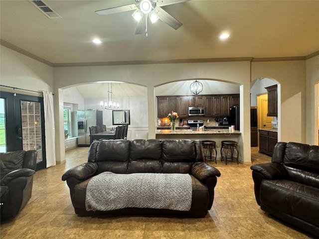 living room with ceiling fan with notable chandelier and ornamental molding