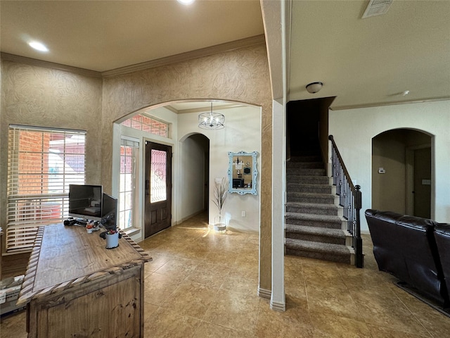 foyer entrance featuring crown molding