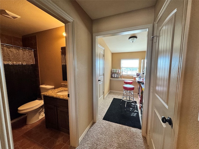 bathroom featuring a shower with curtain, vanity, and toilet