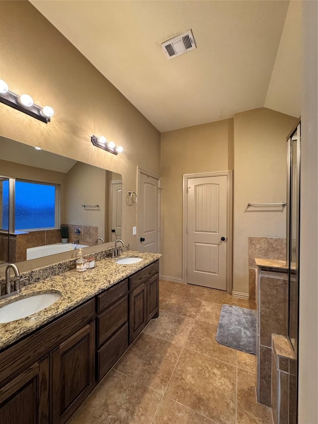 bathroom with walk in shower, vanity, and vaulted ceiling