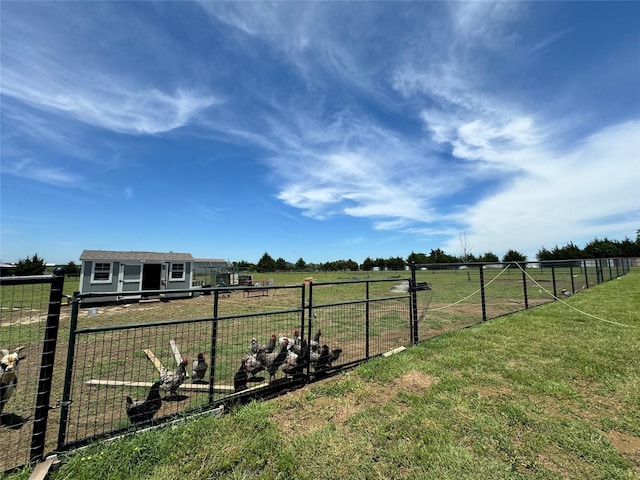 view of yard featuring an outdoor structure and a rural view