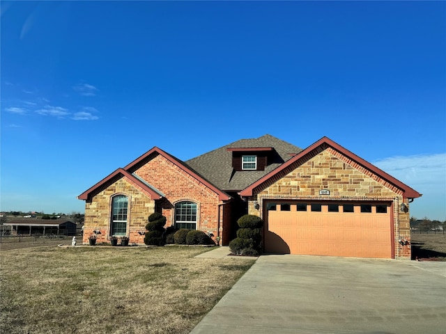 view of front of property with a garage and a front yard