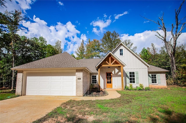 view of front of house featuring a garage and a front lawn