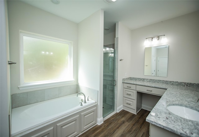 bathroom with vanity, shower with separate bathtub, and wood-type flooring