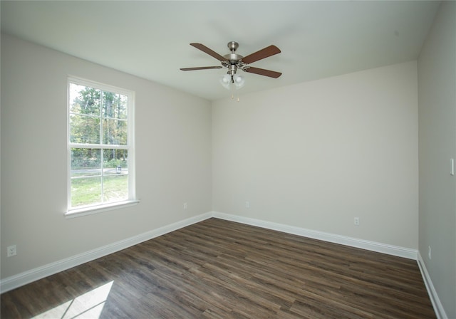 unfurnished room with ceiling fan, dark hardwood / wood-style floors, and a wealth of natural light