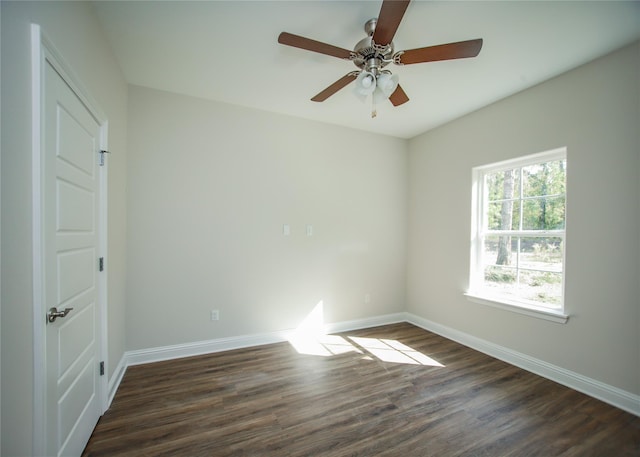 spare room with dark hardwood / wood-style flooring and ceiling fan