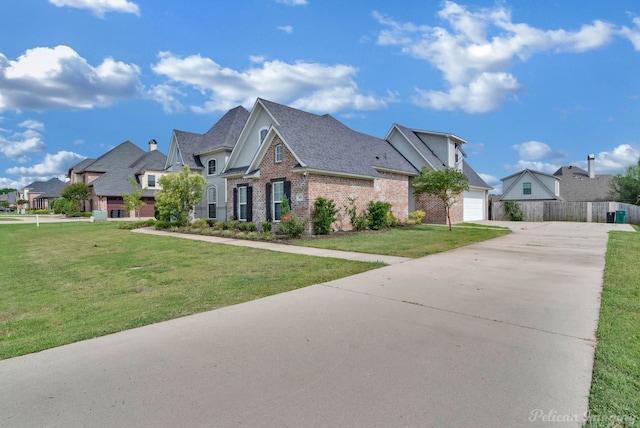 view of front of home featuring a garage and a front yard