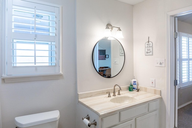 bathroom featuring vanity and toilet