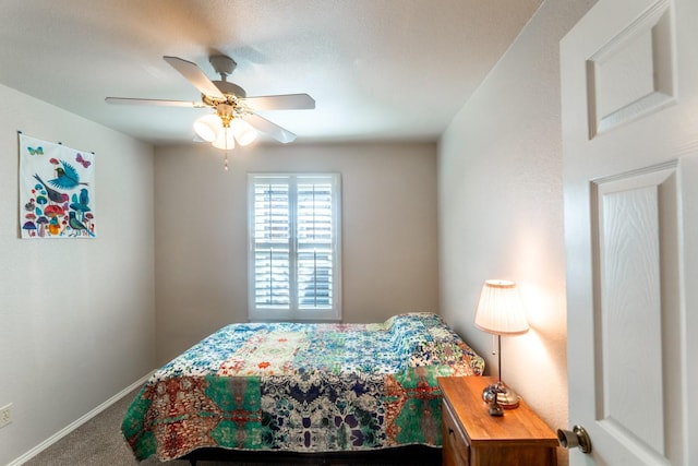 bedroom featuring ceiling fan and carpet