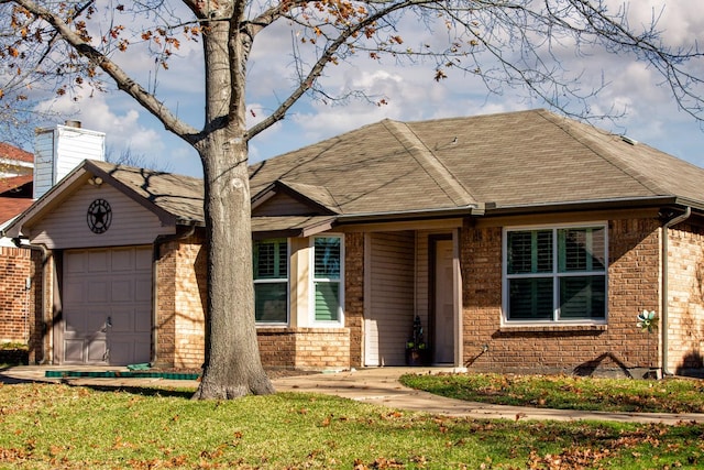 ranch-style home with a garage and a front yard