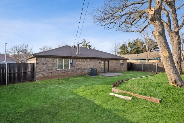 back of property with central AC, a lawn, and a patio area