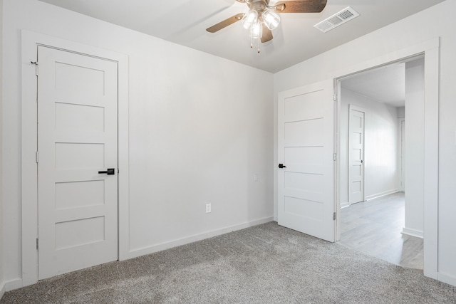 carpeted empty room with ceiling fan