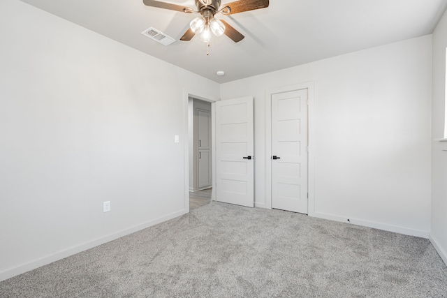 unfurnished bedroom featuring light carpet and ceiling fan