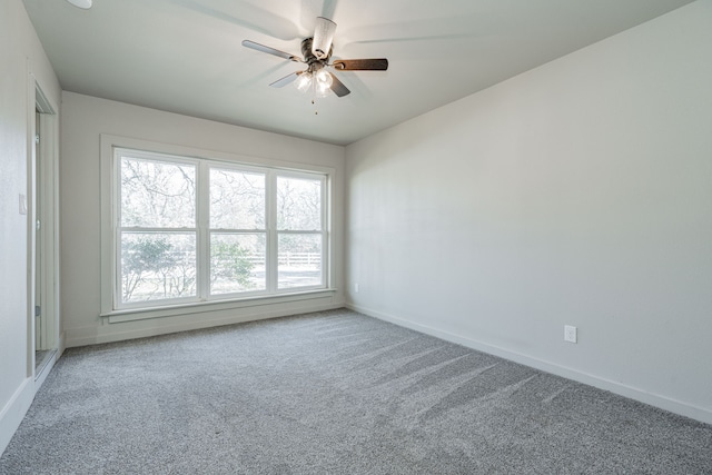 carpeted spare room with ceiling fan