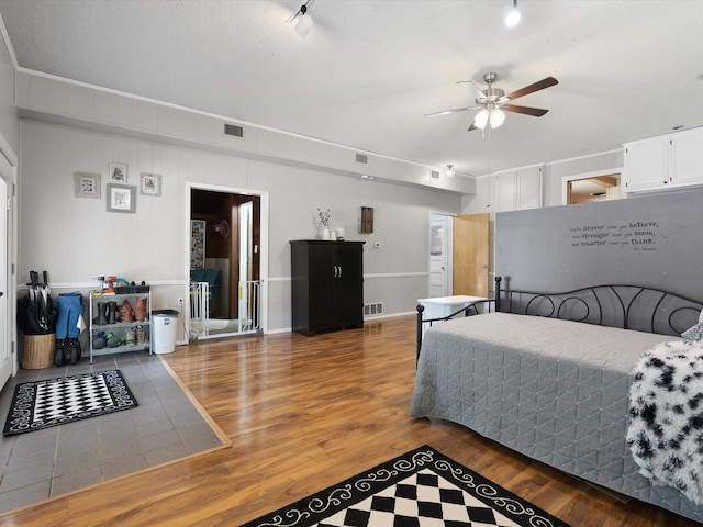 bedroom featuring wood-type flooring and a textured ceiling