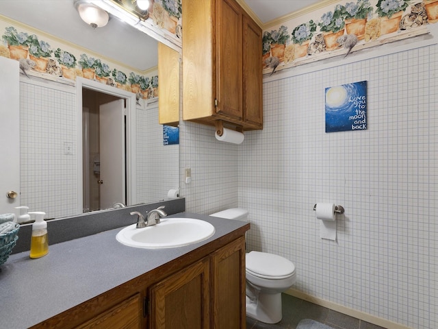 bathroom featuring ornamental molding, vanity, and toilet