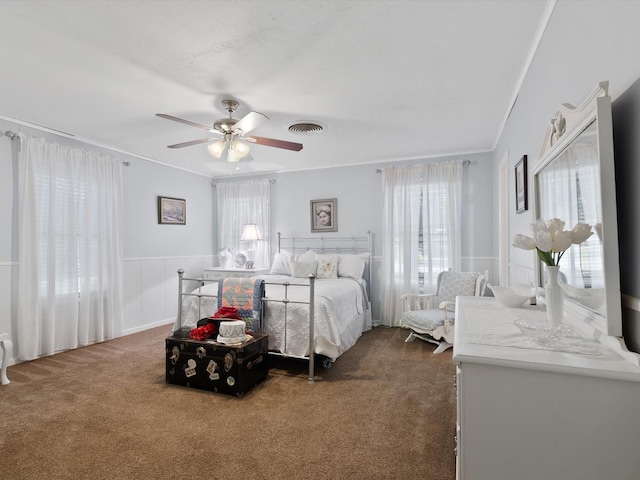 carpeted bedroom with crown molding and ceiling fan