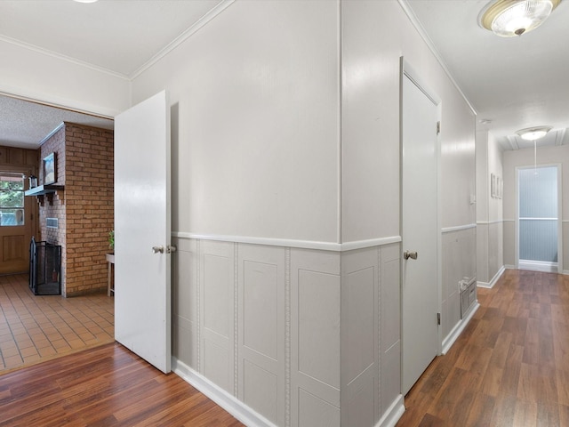 hallway with ornamental molding and dark hardwood / wood-style floors